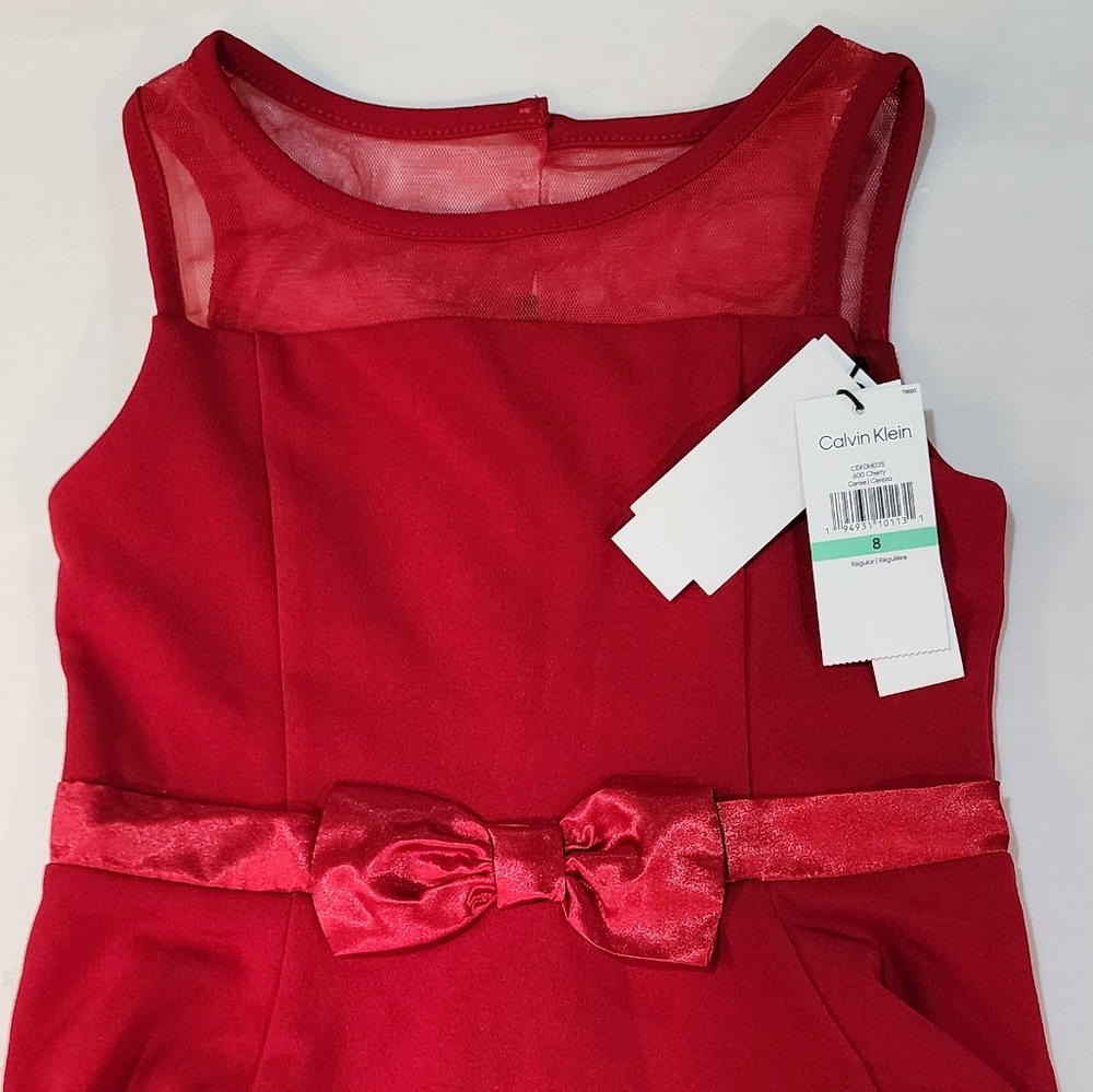 Mesh detailing at the top and bottom and a decorative bow around the waist give